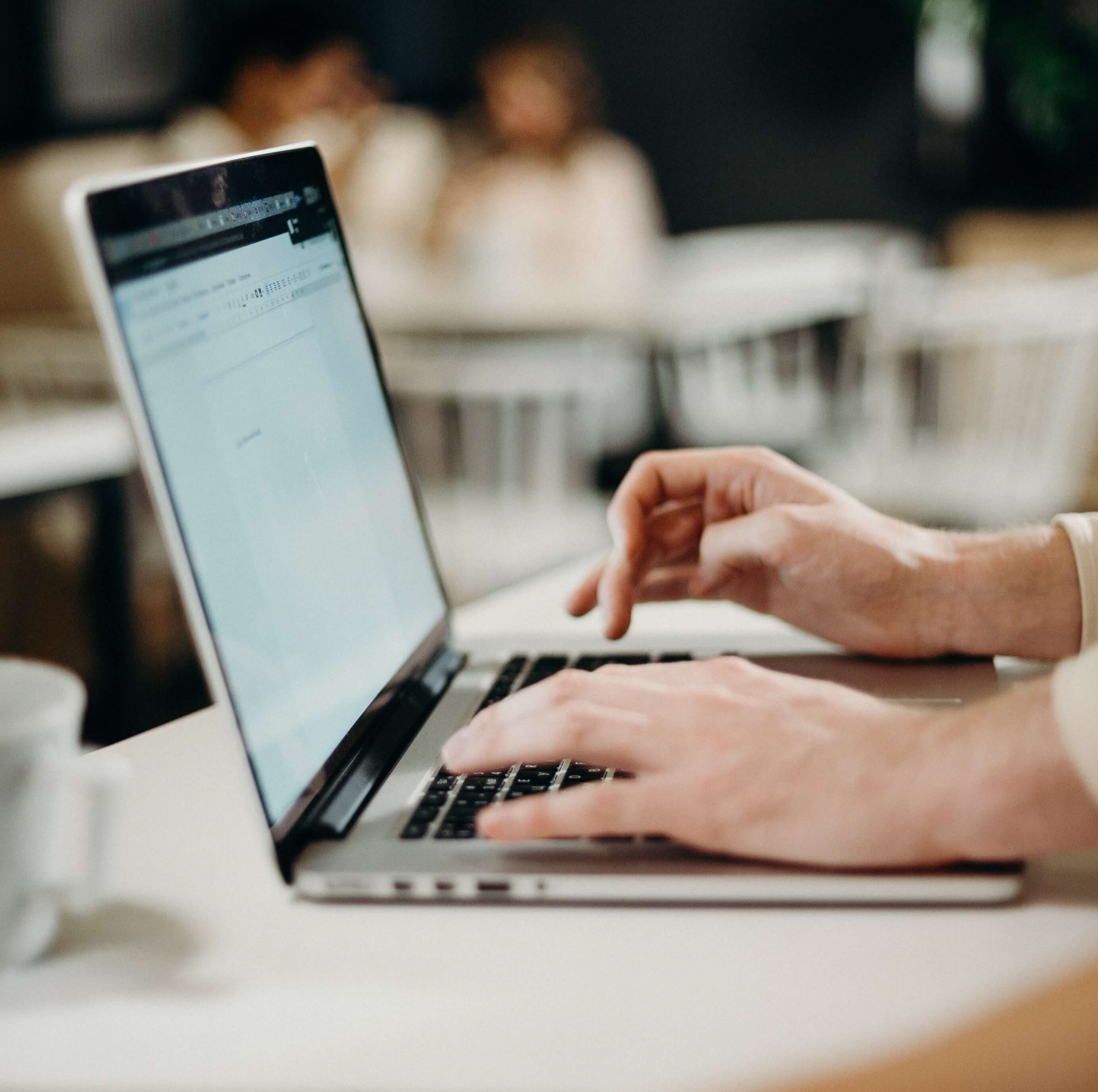 man writing an email on his laptop