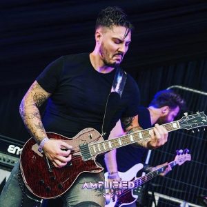 mark williams playing guitar on stage